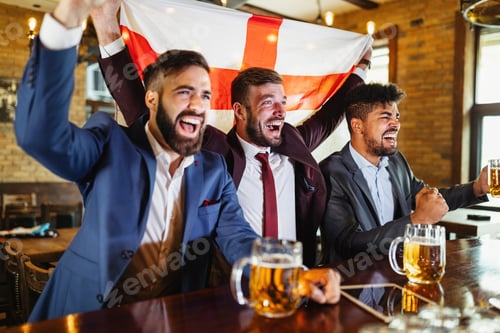 Preview: Business men in pub cheering for a sporting event