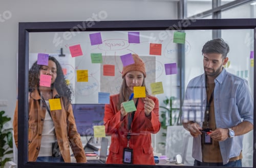 Preview: Multicultural startup team collaborate, brainstorm, exchange ideas using sticky notes for solutions