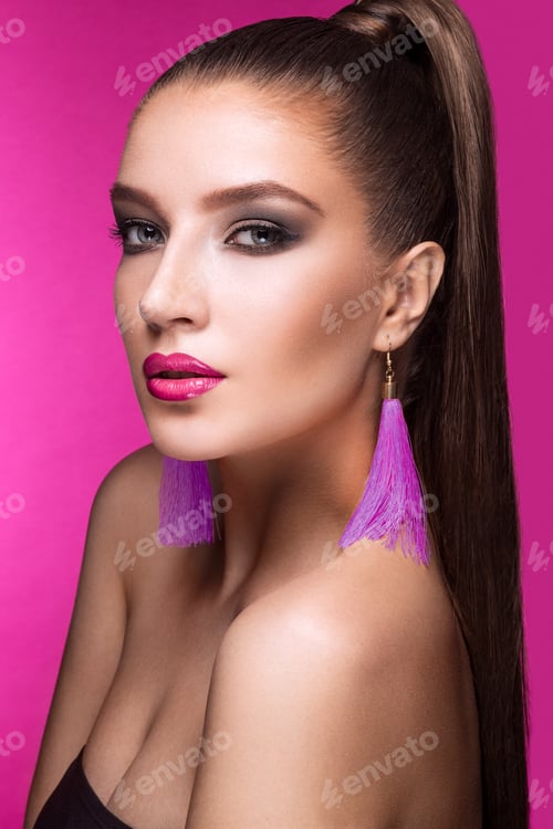 Preview: Woman with makeup and purple tassel earrings