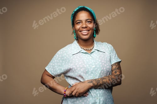 Preview: Young black woman in headband smiling and looking at camera