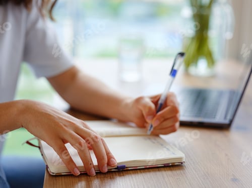 Preview: woman using laptop while working indoors