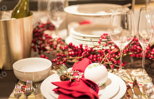 Preview: Table set with pretty dishes and berry garland for holiday entertaining