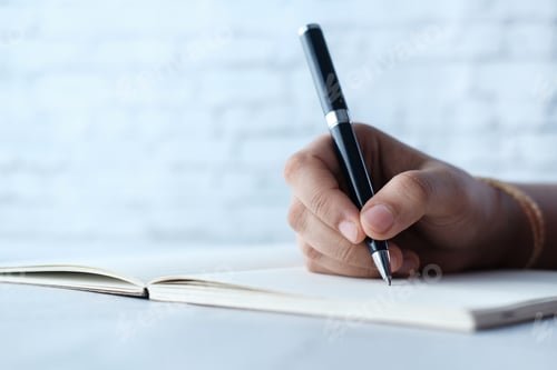 Preview: Close up of women hand writing on notepad.