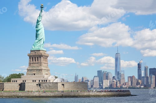 Preview: Statue of Liberty island and New York city skyline in sunlight,