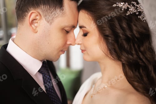 Preview: Portrait of a beautiful bride and groom at their wedding day.