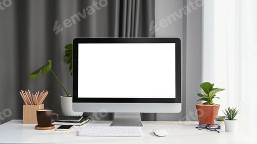 Preview: Front view of mock up computer with blank screen, house plant and office supplies.