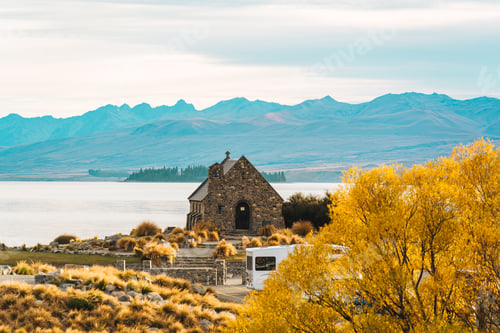 Preview: Famous Church of the Good Shepherd with mountain and yellow grass in autumn at Lake Tekapo