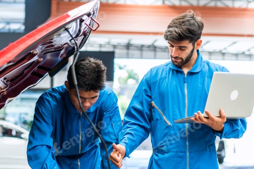 Preview: Mechanic man using laptop diagnostic and repairing car