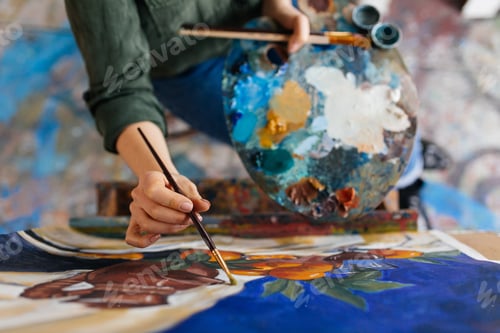 Preview: Top view of attractive woman hands drawing amazing picture on ca