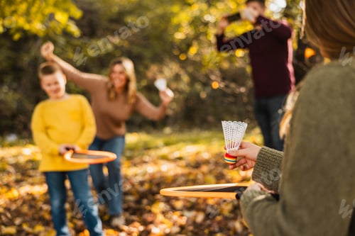 Preview: Family Playing Badminton In Park