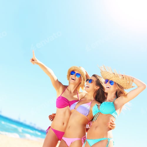 Preview: Group of women pointing at something on the beach