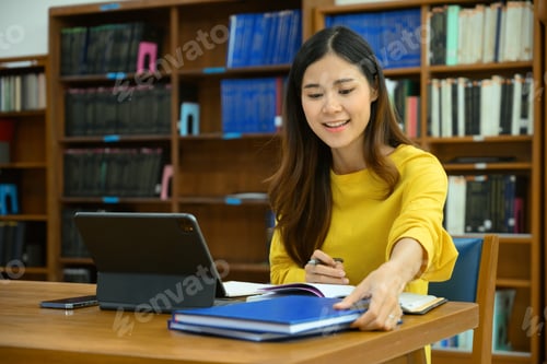 Preview: Shot view of female student learning online via digital tablet before her lectures.