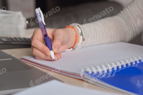 Preview: Student writing in notebook