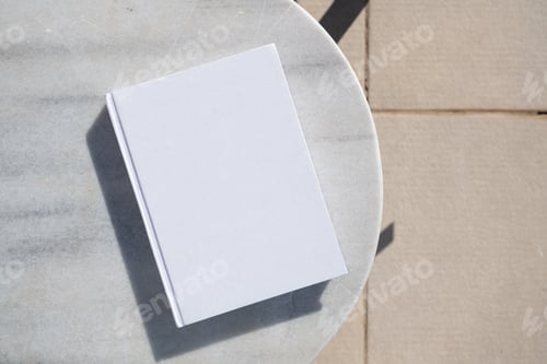 Preview: blank book for mockup design on marble table by the swimming pool
