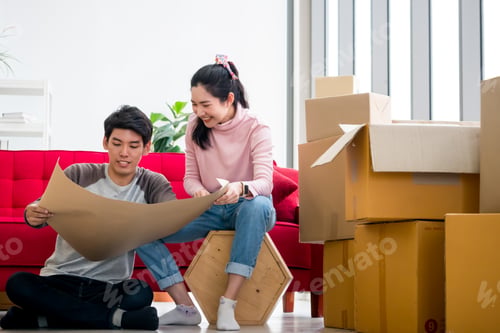 Preview: Happy young couple moving to new house together.