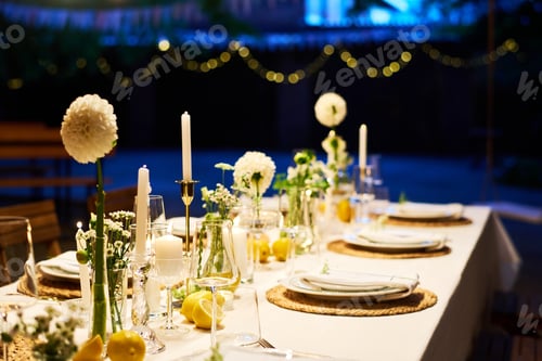 Preview: Part of long festive table decorated with candles and white dahlia flowers