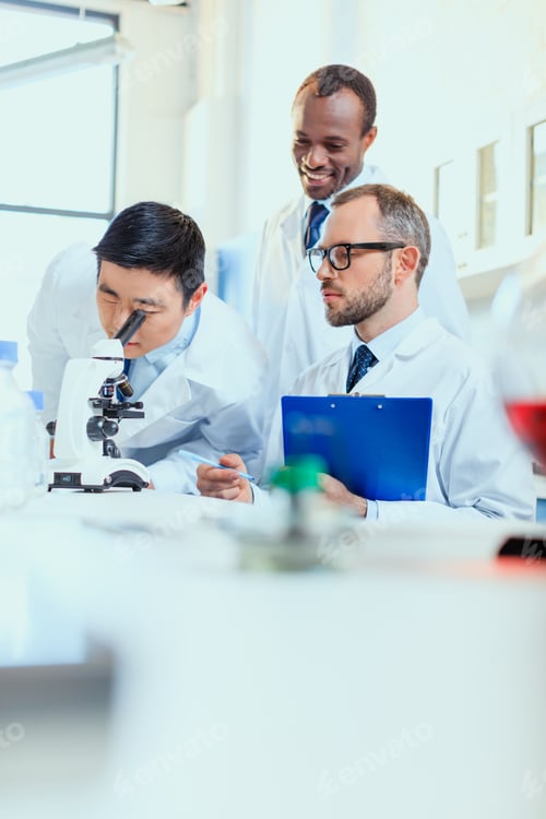 Preview: young doctors in uniform working at testing laboratory, laboratory technicians