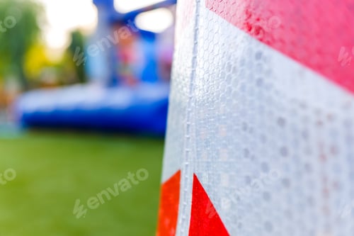 Preview: Detail of a traffic cone with reflective safety material.