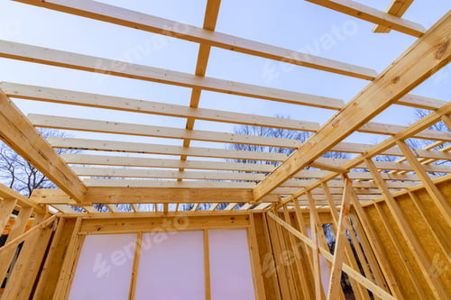 Preview: Construction of a wooden structure with exposed beams during a clear day in an open area