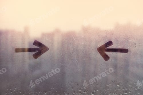 Preview: Foggy glass on window with drawn two arrows opposite each other, concept photo, copy space