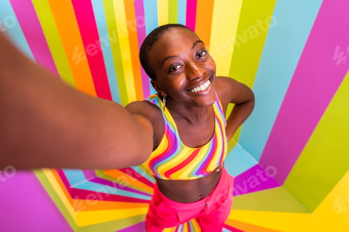 Preview: Beautiful young woman dancing and having fun inside a rainbow box room