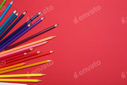 Preview: Colorful pencils on red background, flat lay. Space for text