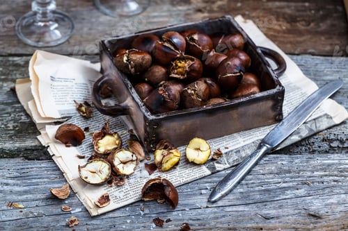 Preview: Roasted chestnuts in an old box. Selective focus.
