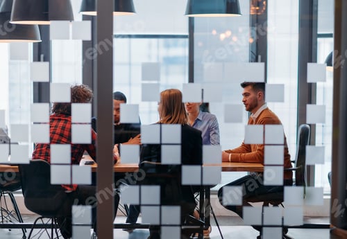 Preview: In a sleek glass office space, a team of business professionals engage in lively discussions and