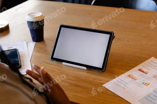 Preview: Plus size african american casual businesswoman making video call using tablet, copy space in office