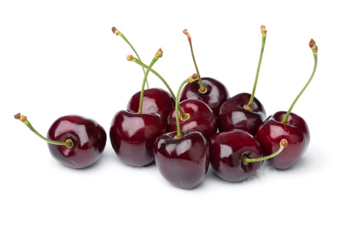 Preview: Heap of fresh red ripe juicy cherries close up on white background