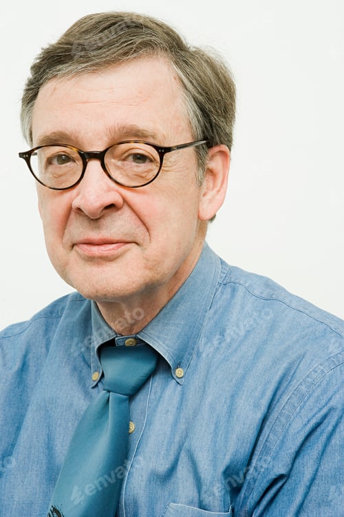 Preview: Senior gentleman smiling in a blue shirt and tie