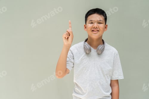Preview: Thai Boy Portrait Against Plain Wall in Natural Light