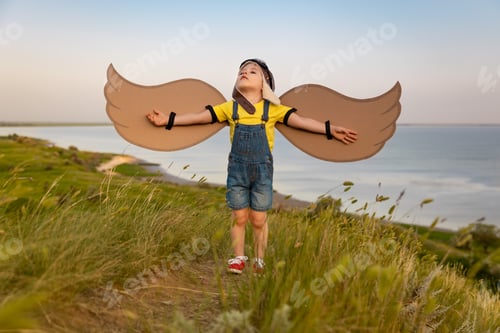 Preview: Happy child against blue sea and sky background