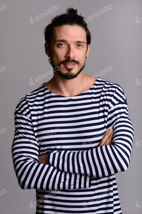 Preview: Studio shot of happy handsome man smiling with arms crossed