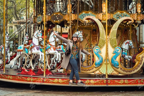 Preview: A girl in a coat on the city carousel in Avignon.France