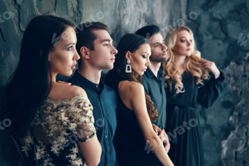 Preview: Group of young beautiful people posing in studio