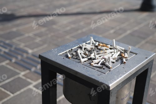 Preview: The collection of cigarette butts found in the outdoor ashtray on a public street