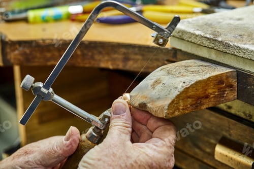 Preview: Jewelry production. Jeweler using saw to create jewelry