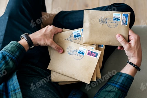 Preview: Aerial view of a man sorting an envelope