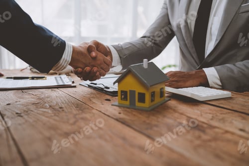 Preview: Real estate broker and client shaking hands after signing sale contract, home loan and congratulatin