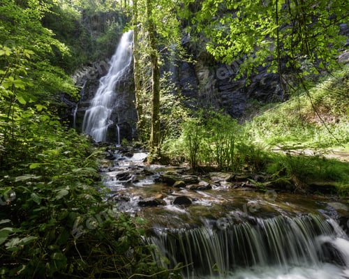 Preview: Small dam in a river downstream of a large waterfall