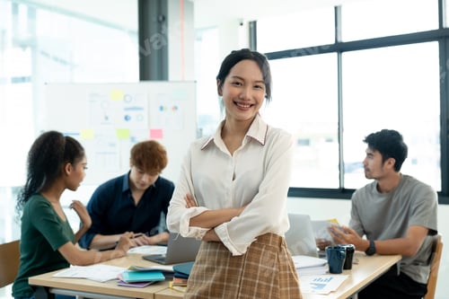Preview: Attractive young asian woman standing confident in the office in front of her team in meeting room.