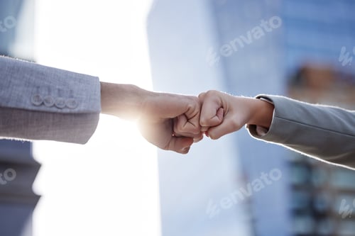 Preview: Right on the money. Shot of two unrecognizable businesspeople giving a fist bump outside.
