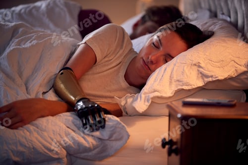 Preview: Couple With Woman With Prosthetic Arm Sleeping In Bed At Home