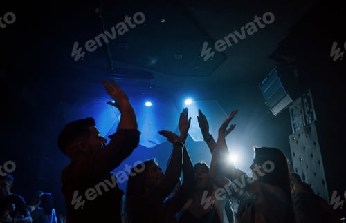 Preview: We are awesome. Group of people that enjoying dancing in the nightclub with beautiful lightings