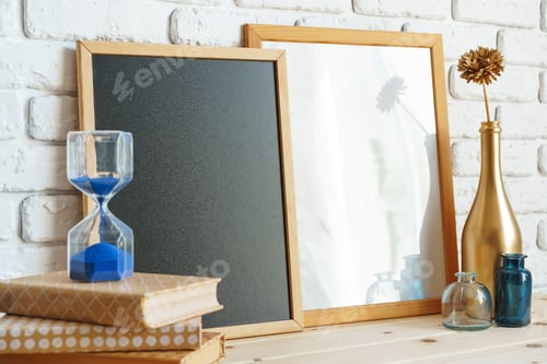 Preview: Wooden frame mockup on table with modern vase and books