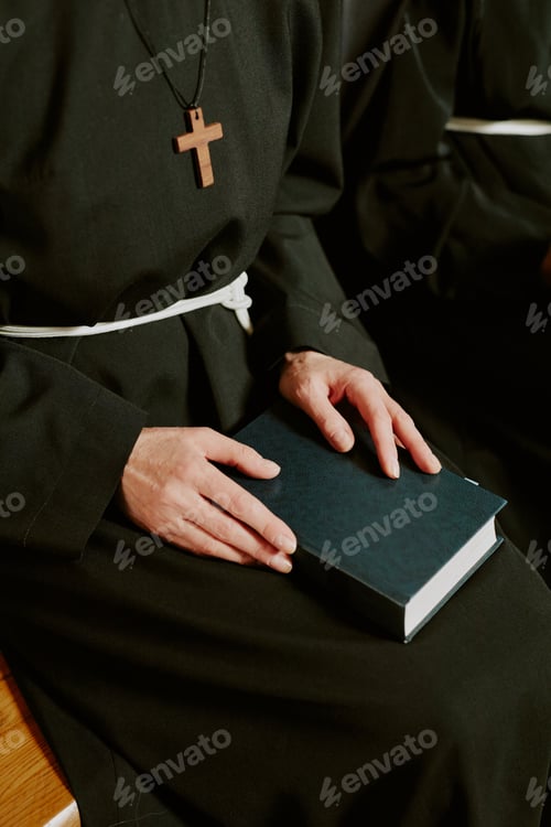 Preview: Unrecognizable Nun Sitting On Bench