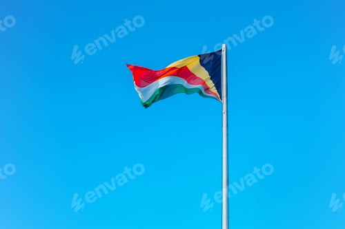 Preview: Colorful Flag Waving Against a Brilliant Blue Sky