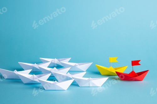 Preview: Red leader paper ship leading among others on blue background. Leadership concept.