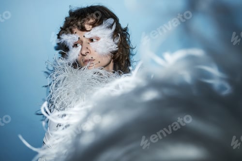 Preview: Caucasian Teen Girl Wearing Feather Mask Creating Artistic Fashion Statement